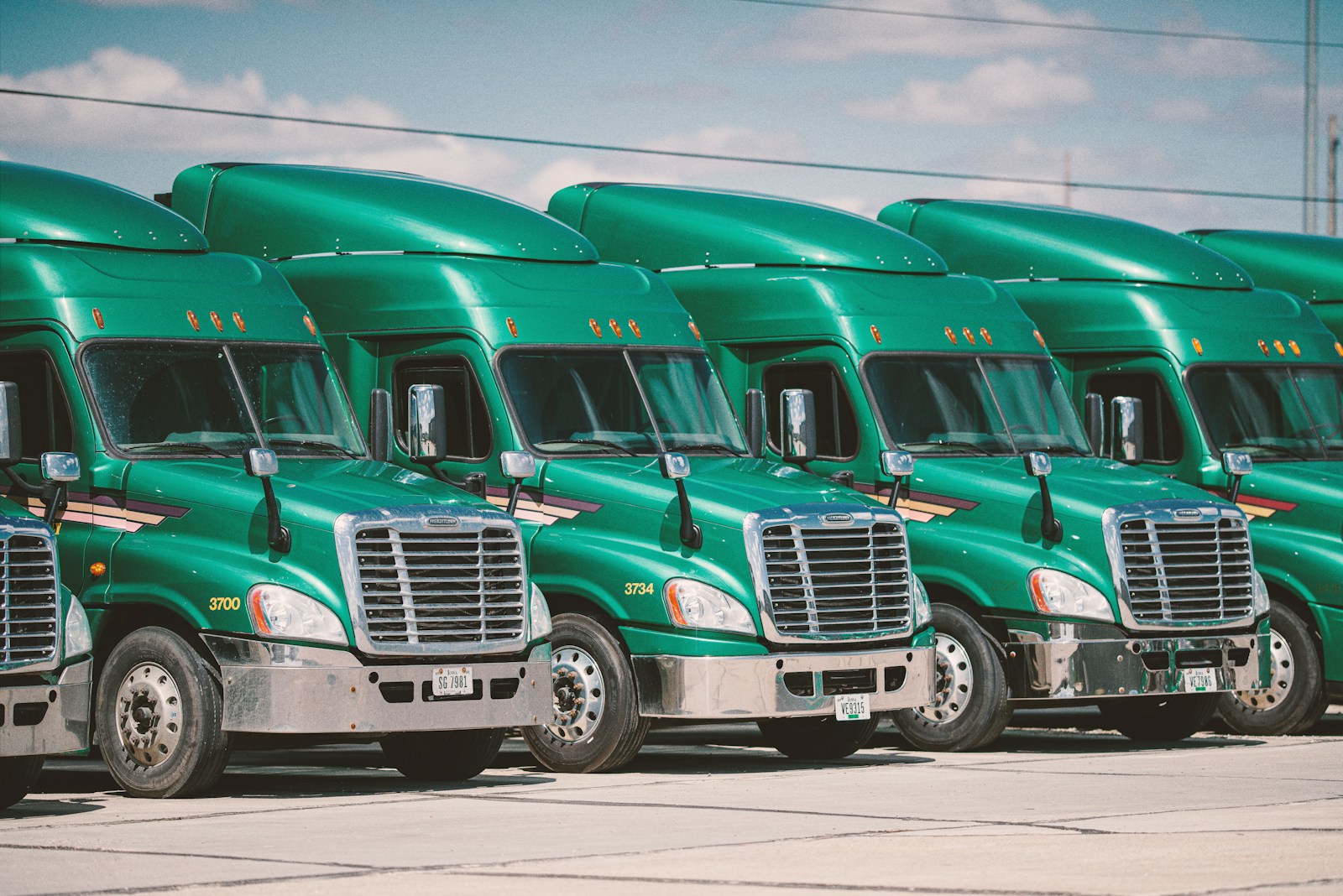 green semi trucks parked